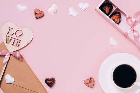 Chocolates festive box cup of coffee, hearts, an envelope pink background. Festive composition for Valentines Dayの写真素材