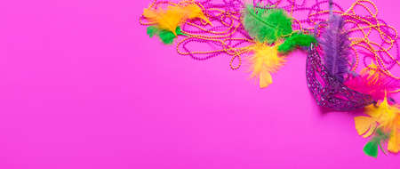 Carnival mask with colored feathers traditional sequin beads for Mardi Gras festival on a purple backgroundの写真素材