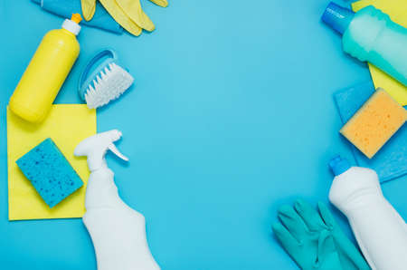 Cleaning kit detergents napkins sponges gloves, blue background. The concept of home cleaning or cleaning company servicesの写真素材