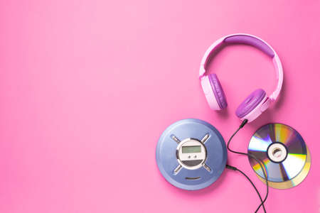Personal compact portable CD player disks purple headphones on a pink background.の写真素材