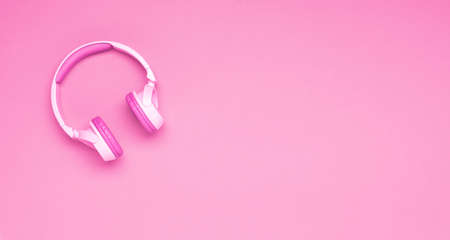 Pink headphones against pink background, flat lay copy space. Hobby entertainment music technologyの写真素材
