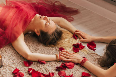 A female reiki master works with patient. Womens circle, concept of mental health, harmony of bodyの写真素材