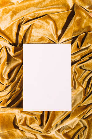 Creative modern background podium, yellow color draped velvet fabric and empty stone board, top viewの写真素材