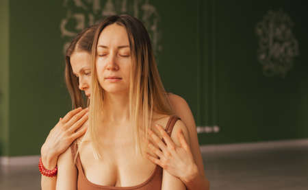 Two women hugging each other reiki session. Womens health, relaxation, rest, mental health harmonyの写真素材