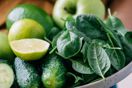 Green vegetables and fruits close-up, soft focus. Vegetarianism healthy lifestyle proper diet foodの写真素材
