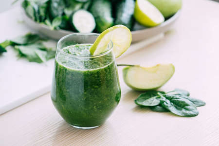 Green vegetable fruit smoothie in various glasses light background, Vegetarianism healthy lifestyleの写真素材