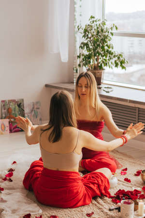 A female reiki master works with patient. Womens circle, concept of mental health, harmony of bodyの写真素材