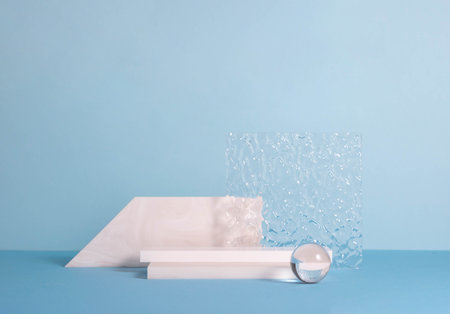 Podiums made of stone and glass, blue background. Abstract product showcase