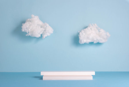 Podiums made of stone and glass, blue background with white clouds. Abstract product showcaseの写真素材