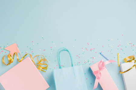 Gift boxes serpentine confetti and glitter packages, festive blue background. Party birthday conceptの写真素材