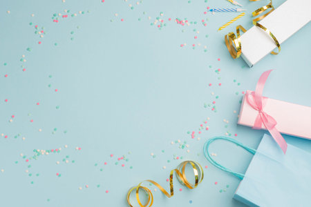 Gift boxes serpentine confetti and glitter packages, festive blue background. Party birthday conceptの写真素材