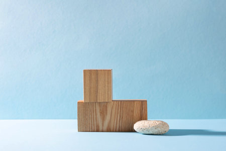 Podiums made of wooden figures, hard shadows. Abstract modern product showcase blue backgroundの写真素材