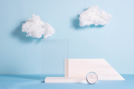 Podiums made of stone and glass, blue background with white clouds. Abstract product showcaseの写真素材