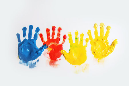 Childrens palms in bright paint, yellow red blue color. Autism, learning, creativity of children. Illustration, Generative AIの素材