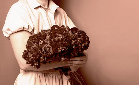 Woman holding bouquet of flowers, monochrome styleの写真素材