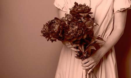 Woman holding bouquet of flowers, monochrome style