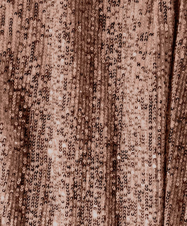 Shimmering rose gold sequin fabric with elegant sparkle and textureの写真素材