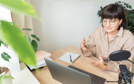 Woman explaining during online meeting from home officeの写真素材