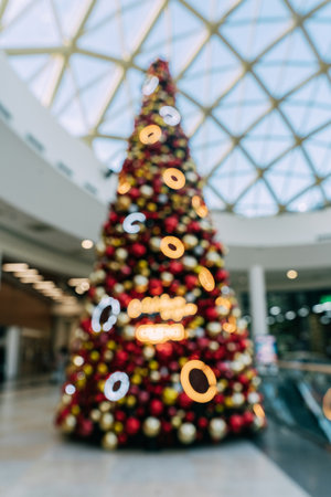 Giant blurred christmas tree in shopping mall with decorative lights, festive Sparkle Blurred Backgroundの写真素材
