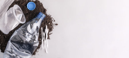 Plastic waste polluting soil with disposable items