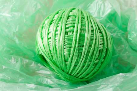 Green plastic twine ball on crumpled bagの写真素材