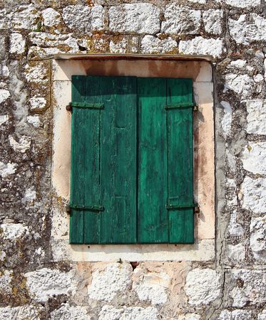 Old window blinds painted greenの写真素材