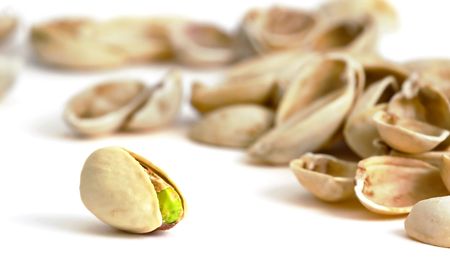 Single pistachio with empty shells