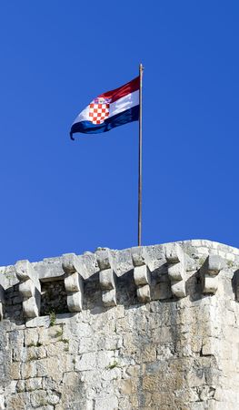 Croatian tricolor flying over castle battlementの写真素材