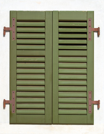 Closed window blinds painted greenの写真素材
