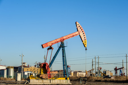 Oil pumps are running in the sunset at the oil field. On the Bohai coast of China.のeditorial素材