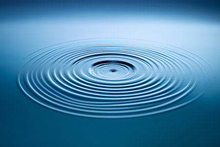 Water ripples on a blue background. Shallow depth of field.の素材
