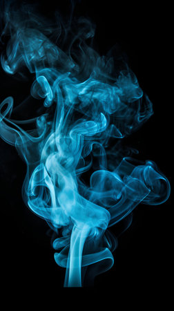 Blue smoke isolated on black background. Abstract background. Design element.の素材
