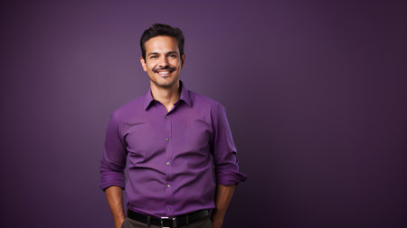 Portrait of a handsome young Indian man in purple shirt posing over purple background.の素材