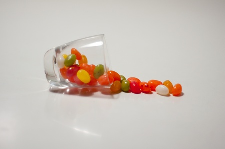 jelly beans in a glass on white backgroundの写真素材