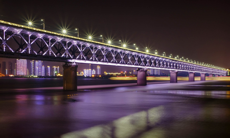 Night time at double deck bridge at Wuhan Yangtze River Bridge. Itâ€™s famous for travel. Many...