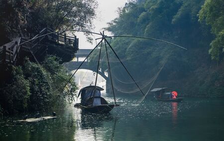 YICHANG, HUBEI / CHINA - DEC 25 2019:  The actress wear the chinese traditional for show the tradition life and China promoted the travelling spot at Long Jin Xi ancient village of Three gorges dam. The part of the Yangtze River in Yichang, Hubei China.のeditorial素材