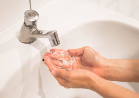 Woman washing hand with running water and soap for coronavirus protection, Hygiene to stop outbreak covid-19 concept.の写真素材