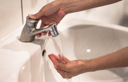 Woman washing hand with running water for coronavirus protection, Hygiene to stop outbreak covid-19 concept.の写真素材