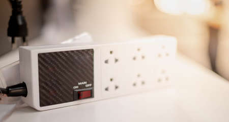 The electrical white external adapter plug  with power button and six outlets. Electric power strip...