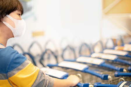 The asian girl pushing the trolley cart shopping the decorate funiture for interior inside the house...
