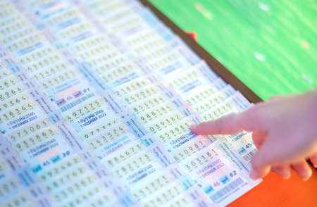 Bangkok, Thailand - November 29, 2022 : The female hand choosing Thailand goverment lottery from the street vendor.の写真素材