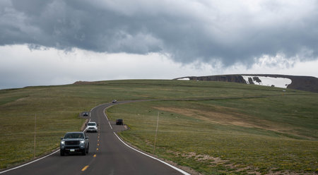 Beautiful view from a car on the Rocky Mountains in Apine visitor center. Panorama of a road in the mountains past a meadows on a cloudy day in summer, Colorado.の写真素材