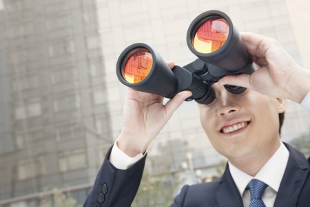 Smiling Businessman Using Binoculars, Reflectionの写真素材