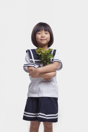 Girl Hugging Potted Plantの写真素材