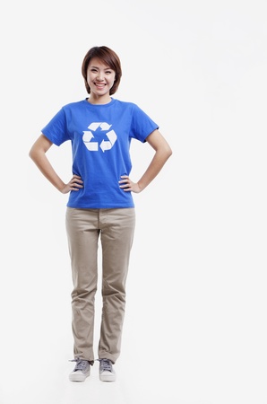 Portrait of young woman wearing recycling symbol T-shirt, studio shotの写真素材