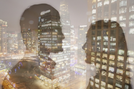 Double exposure of young couple over night cityscape の写真素材