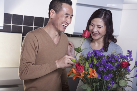 Mature Couple with Bouquet of Flowers, Man Holding a Roseの写真素材
