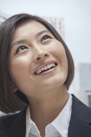 Portrait of Smiling Young Businesswoman, Looking upの写真素材