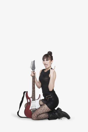 Punk Rocker Kneeling with Guitarの写真素材