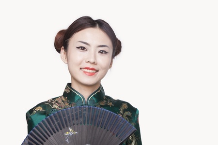 Young Woman in Qipao with Fanの写真素材